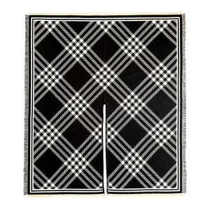 Classic black and white checkered poncho wrap with fringe hem and open front style