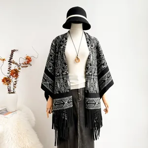 Ethnic style knit poncho for women with black and grey geometric patterns and long fringes