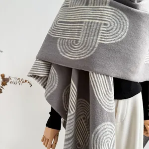 Detailed texture of thick grey ethnic shawl with white geometric jacquard pattern