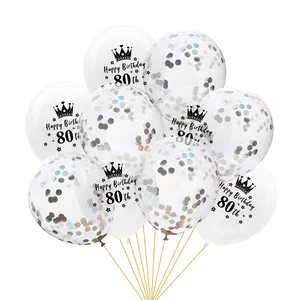 Detail of 80th birthday transparent balloons with black print and gold confetti inside