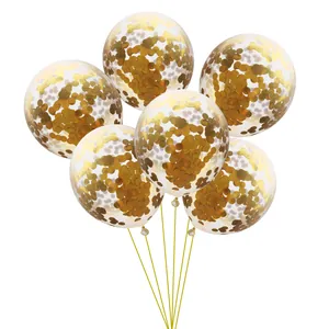 Detail of 6 clear balloons filled with golden round confetti and tied with gold ribbons