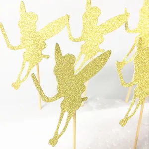 Detailed view of gold glitter fairy cake toppers with wings on wooden sticks