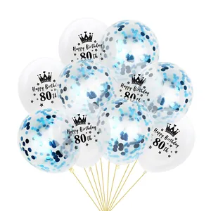 Close-up of 80th birthday balloons with blue confetti and crown happy birthday print