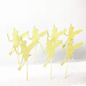 Detailed view of 5-piece gold glitter fairy cake toppers with wings and wooden sticks