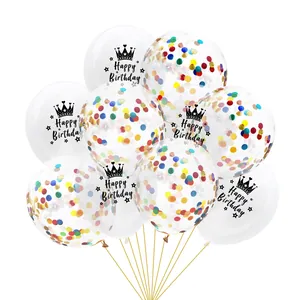 Close-up of clear latex balloons with Happy Birthday print and colorful paper confetti