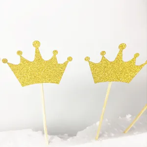 Close-up of glittery golden crown cake topper for wedding and party decorations