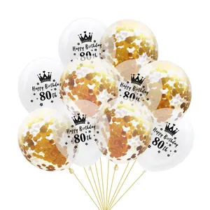 Macro shot of transparent 80th birthday balloons with gold confetti and crown prints