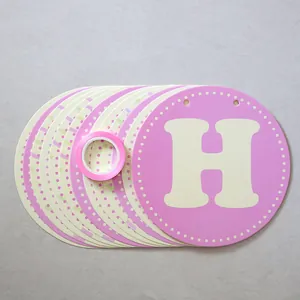Pink and beige round birthday banner with letters and ribbon for party decoration