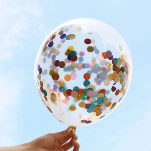 Macro shot of 12-inch transparent latex balloon filled with colorful confetti sequins