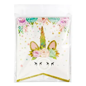 Detailed view of unicorn party banner cards with gold foil horn and floral design