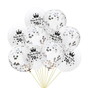 Close-up of 70th birthday clear balloons with gold confetti and crown prints