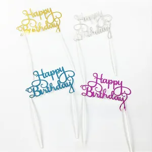 Close-up of sparkling Happy Birthday cake toppers in gold silver blue and purple glitter