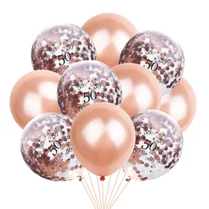 Detail of rose gold 50th anniversary balloons with shiny metallic and confetti texture