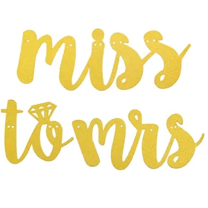 Close-up of gold glitter Miss to Mrs banner featuring a diamond ring graphic for weddings