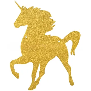 Close-up of golden glitter unicorn paper banner with cutout holes for birthday party decor