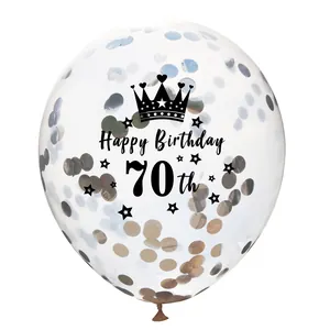Detail of transparent 70th birthday balloon with gold and silver confetti and crown