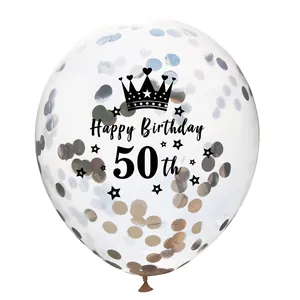 Detailed view of clear 50th birthday balloon with gold confetti and black crown print