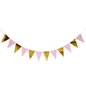 Close-up of pink and gold foil triangle bunting flags with glossy metallic finish