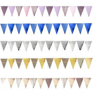 Detail view of metallic gold, silver, and blue triangular banners with wave patterns
