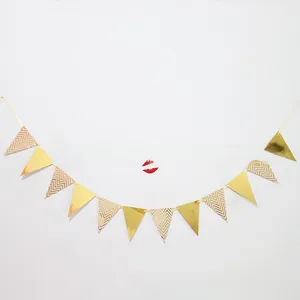 Detail of gold foil pennant banner with metallic triangle flags for party decoration