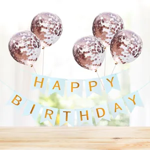 Blue Happy Birthday banner with rose gold confetti balloons on a wood table