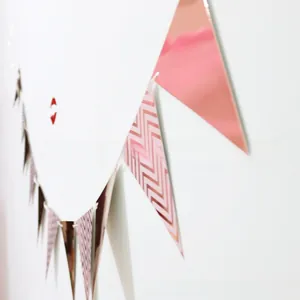 Detail of rose gold and pink chevron pennant banner flags for party background decoration