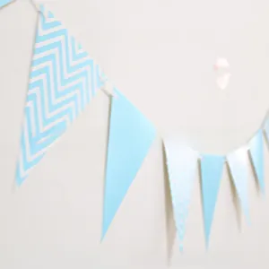 Detail of light blue and chevron pattern triangle bunting flags for party decorations