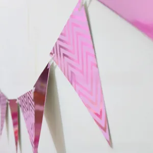 Detail of pink metallic triangle bunting flags with wavy pattern for party decor