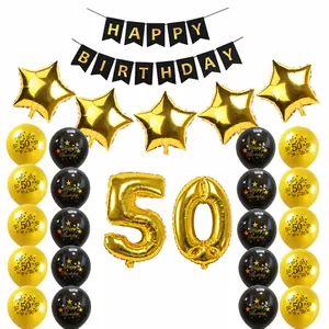 Close-up of black and gold 50th birthday party kit with balloons and bunting