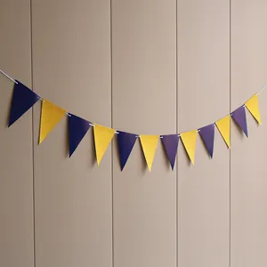 Close-up of purple and gold glitter triangular bunting banners for birthday party decoration