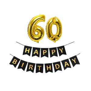 Close-up of gold number 60 foil balloons and Happy Birthday banner with gold lettering