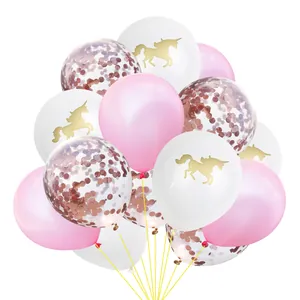 Detailed close-up of rose gold confetti balloons and gold unicorn prints for party decor