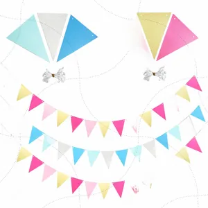 Vue détaillée de guirlandes de fanions colorés bleu, rose et paillettes dorées pour fête