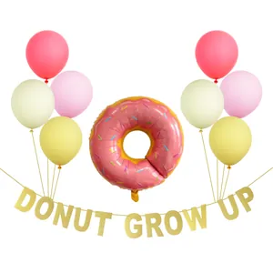 Pink donut balloon with Donut Grow Up gold banner and pastel latex balloons party set