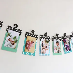 Detail of baby monthly milestone photo banner with colorful frames and polka dot bowties