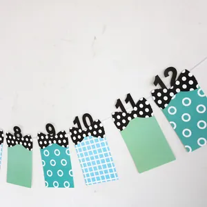 Baby first birthday photo banner with numbered cards and polka dot bows for party decor