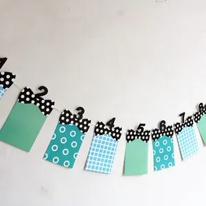 Detail of blue and green paper bunting banners with 1-12 months photo frames for baby birthdays