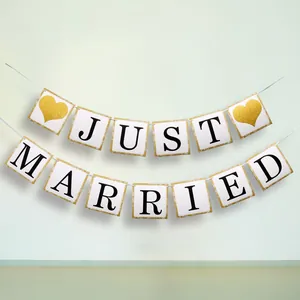Detail of glitter heart and Just Married banner for wedding reception decorations