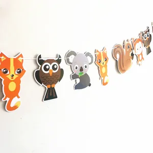 Close-up of jungle animal party bunting featuring cute fox, owl, and koala cardboard cutouts