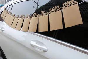 Close-up of monthly milestone photo banner showing cutout letters and kraft paper