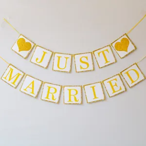 Glittery gold Just Married banner with heart symbols for wedding party decoration