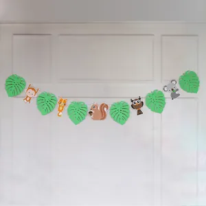 Detail of woodland animal banner with fox, owl, and squirrel paper cutouts for parties