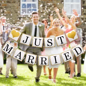 Just Married banner with gold glitter hearts displayed at a joyful wedding celebration