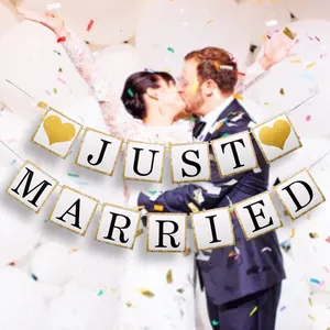 Close-up of glittery Just Married banner with gold hearts for wedding decor ceremony