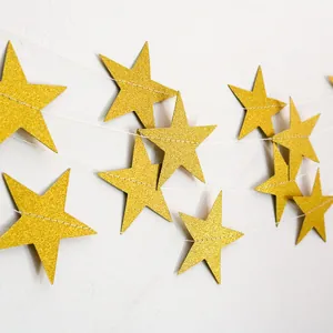 Close-up of 4m gold glitter star garland decoration with sparkling texture for parties