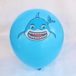 Detailed close-up of a blue 12-inch latex balloon with a smiling cartoon shark print
