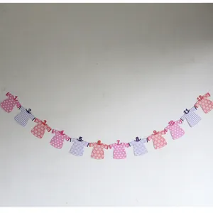 Pink and purple baby first birthday banner with twelve numbered clothing shapes for photos