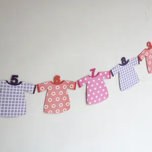 Colorful baby first birthday photo banner with clothes-shaped paper card decorations