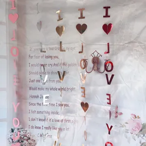 Close-up of metallic 'I LOVE YOU' heart garlands in pink, gold, and red for room decor