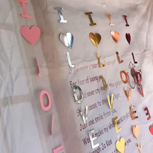 Detail of I LOVE YOU heart banners with metallic glitter finish for wedding decoration